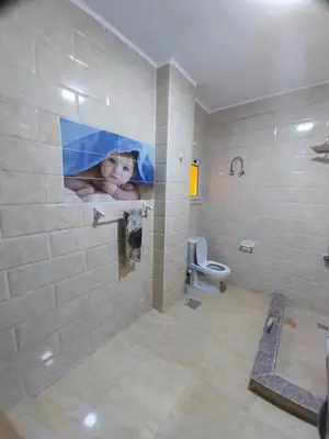 a bathroom with a painting of a child on the wall at Emad villa in Hurghada