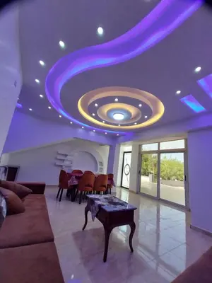 a living room with a purple ceiling and a table at Emad villa in Hurghada