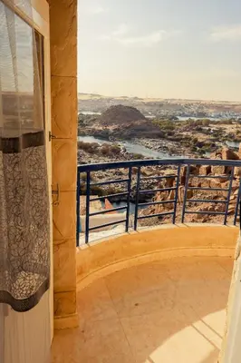 a balcony with a view of a river at Nubian Hights guesthouse in Shellal