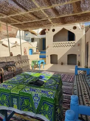 a large room with a table and a stage at Nubian Hights guesthouse in Shellal