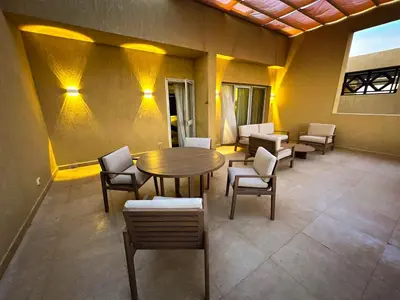 a room with a wooden table and chairs and a table at The Zen Wellness Resort in Aswan