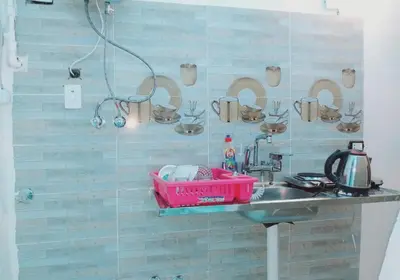 a bathroom with a sink and a counter with cups on the wall at Nubian Amego Gaust House in Aswan