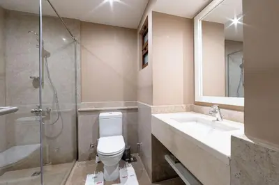a bathroom with a toilet and a sink and a shower at Sabina Lagoon view 2BR Apartment in Hurghada