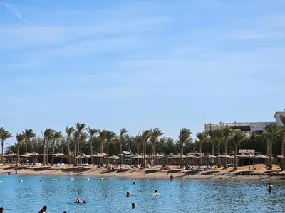 a group of people in the water at a beach at Noura Luxury Hotel Villa with free Pool and Beach access in Hurghada in Hurghada