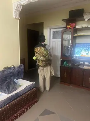 a man with a backpack standing in a room at Alara Hostel 