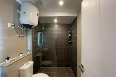 a bathroom with a toilet and a shower at The Senseful Studio G Cribs in Hurghada