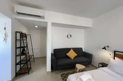 a living room with a couch and a bed at The Senseful Studio G Cribs in Hurghada