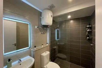 a bathroom with a toilet and a sink and a mirror at The Senseful Studio G Cribs in Hurghada