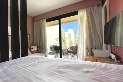a bedroom with a bed and a large window at The Snuggly Studio G Cribs El Gouna in Hurghada