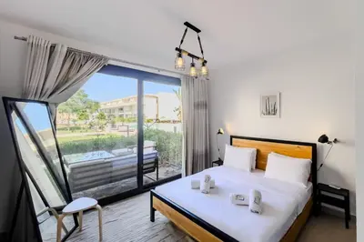 a bedroom with a bed and a large window at Cordial & Cozy 1 BDR G Cribs in Hurghada