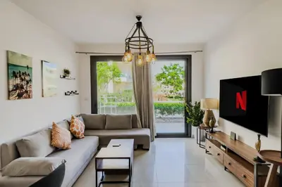 a living room with a couch and a tv at Cordial & Cozy 1 BDR G Cribs in Hurghada