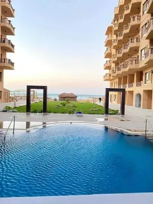 a large swimming pool in front of a building at Turtles Beach resort hourghada Studio view sea view pool private beach Pools balcony security Cafe and restaurant on pool jacuzzi air-condition sunny a large balcony in Hurghada