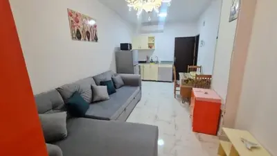 a living room with a couch and a kitchen at Turtles Beach resort hourghada Studio view sea view pool private beach Pools balcony security Cafe and restaurant on pool jacuzzi air-condition sunny a large balcony in Hurghada