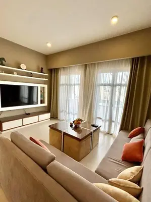 a large living room with a couch and a tv at SunShine AbuTig Marina in Hurghada