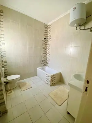 a bathroom with a tub and a toilet and a sink at Villa 6 in Hurghada