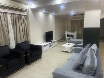 a living room with a couch and a tv at Hurghada-Magawish Villa 6 in Hurghada