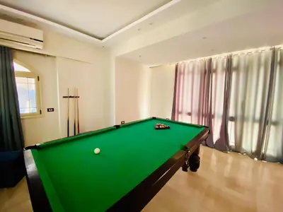 a pool table in a living room with afits at فيلا 1☆ in Hurghada