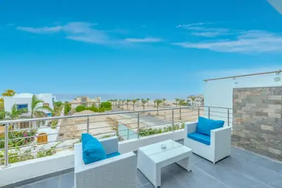 a balcony with a view of the beach at unique villa with heated pool and Spa in Hurghada