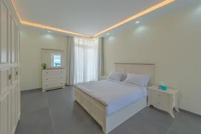 a white bedroom with a bed and a window at unique villa with heated pool and Spa in Hurghada
