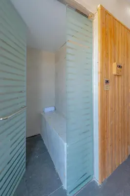 a walk in shower with a glass wall at unique villa with heated pool and Spa in Hurghada