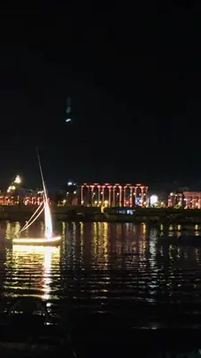 a small boat in the water at night at Roses House Ladies or families only in Luxor