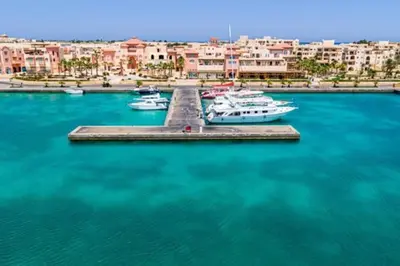 a group of boats docked at a dock in a harbor at Modern Soma Bay 2BR Villa w sea views, beach & pool access in Hurghada