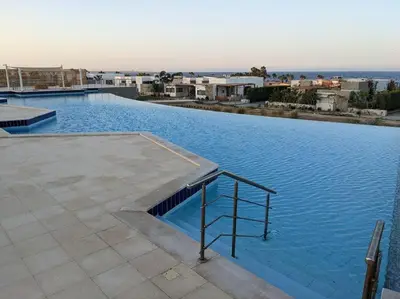 a large swimming pool with blue water at Modern Soma Bay 2BR Villa w sea views, beach & pool access in Hurghada