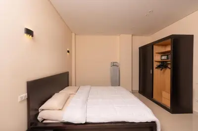 a bedroom with a bed and a wooden cabinet at One bedroom with sea view in the centre in Hurghada