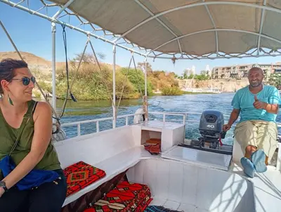 a man and a woman on a boat on the river at Kashta Nubian Guest Houst in Aswan