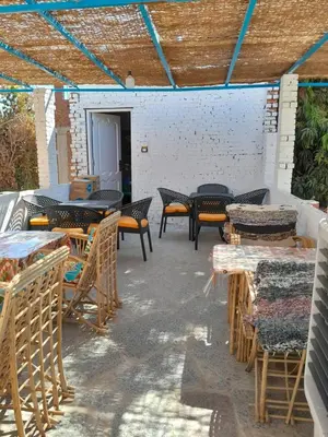 a patio with tables and chairs on a patio at Kashta Nubian Guest Houst in Aswan
