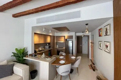 a kitchen and living room with a table and chairs at Captivating 1 BDR Fanadir Marina in Hurghada