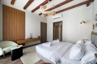 a bedroom with a white bed and a couch at Captivating 1 BDR Fanadir Marina in Hurghada