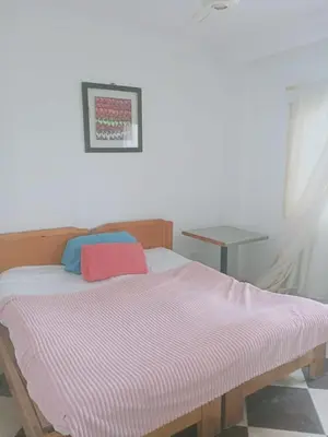a bed with a pink and white blanket on it at Sheraton Plaza Marina Blast 2 bedroom 2 bathroom in Hurghada
