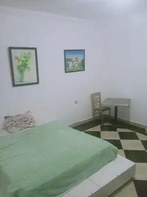 a bedroom with a bed and a table and a chair at Sheraton Plaza Marina Blast 2 bedroom 2 bathroom in Hurghada