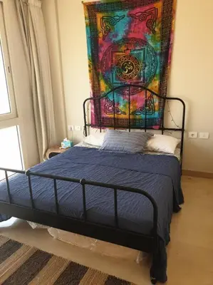 a bedroom with a bed with a painting on the wall at Mangroovy - Divine 1BR Hotel view in Hurghada