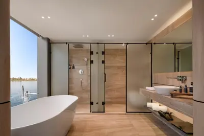 a bathroom with a tub and a sink and a shower at STORIA THE DAHABEYA - Mondays from Luxor for 4 & 7 Nights, and Fridays from Aswan for 3 & 7 Nights - Available for Private Bookings in Luxor