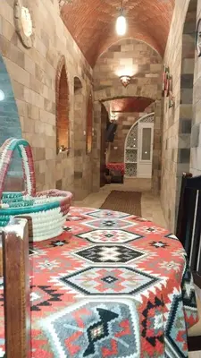 a room with a table with a patterned table cloth at Shahhat Flat in Luxor