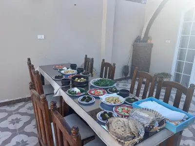 a table with many plates of food on it at West Bank luxury villa in Luxor