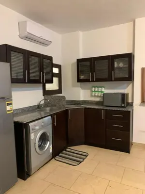 a kitchen with a washer and a washing machine at Hurghada Concierge at Turtles Beach Resort in Hurghada