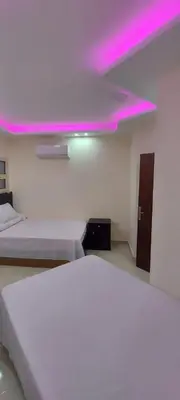a room with two beds and a purple ceiling at Casablanca beach family suites in Hurghada