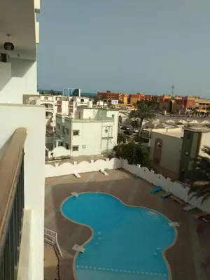 a view of a swimming pool on top of a building at Al makramia Compound in Hurghada