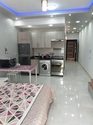 a large kitchen with stainless steel appliances and a table at Al makramia Compound in Hurghada