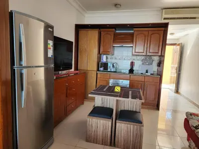 a kitchen with wooden cabinets and a stainless steel refrigerator at apartment in hurghada307 in Hurghada