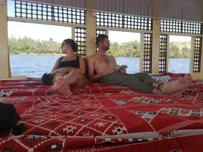 a group of people sitting on a bed at Aswan Felucca sailing boat and Hotel in Aswan