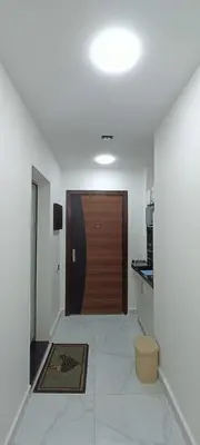 a hallway with a brown door in a kitchen at Floranza khamsin hurgada منتجع فلورنزا الغردقه in Hurghada