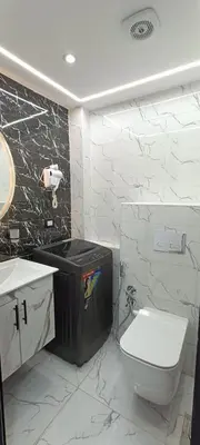 a white bathroom with a toilet and a sink at Floranza khamsin hurgada منتجع فلورنزا الغردقه in Hurghada