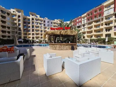 a patio with white chairs and a fountain with buildings at Floranza khamsin hurgada منتجع فلورنزا الغردقه in Hurghada