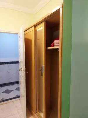 a closet with an open door in a room at شقة 327صغيرة جميلة هادئة وسط المدينة in Hurghada