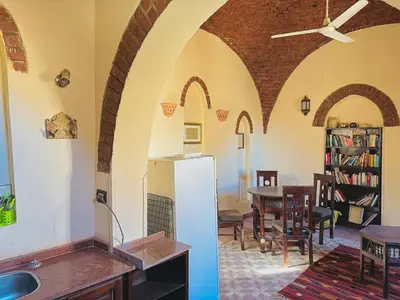 a kitchen and dining room with a white refrigerator at Ramses Apartment in Luxor