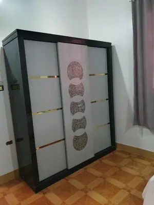 a closet with glass doors in a room at Soliman Villa in Luxor